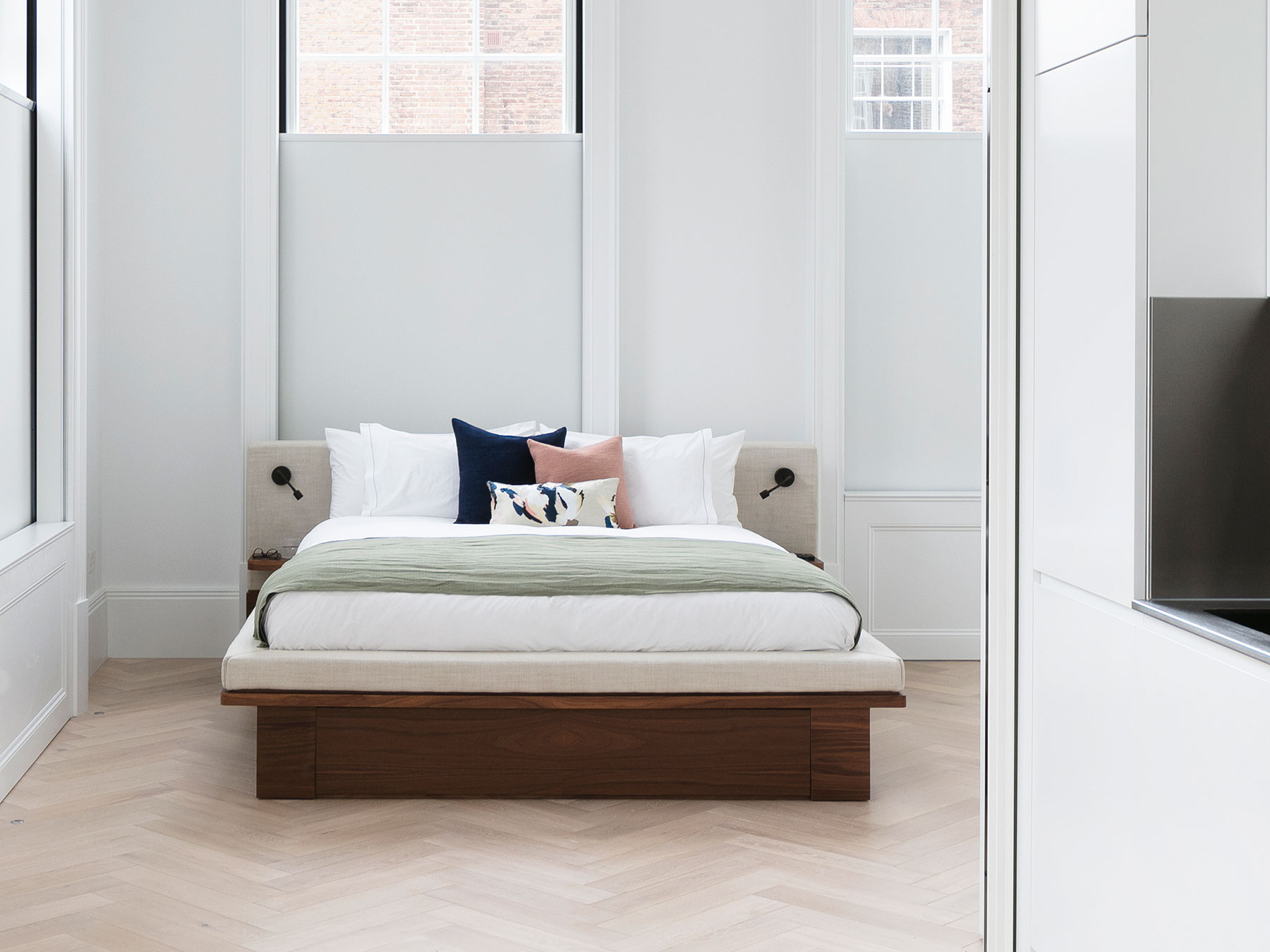 This unique custom bed features a discrete built-in TV lift to maintain the minimalist aesthetic