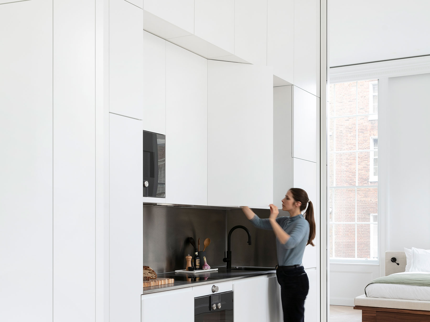 Full height custom integrated kitchen with floor to ceiling units and panelling