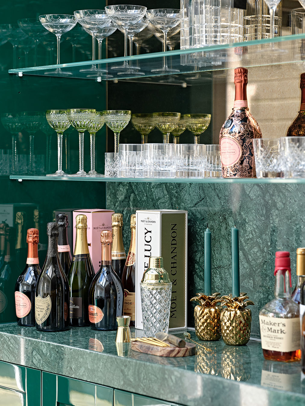 Deatil of bar highlighting marble worktop, glass shelves and and gloss finish