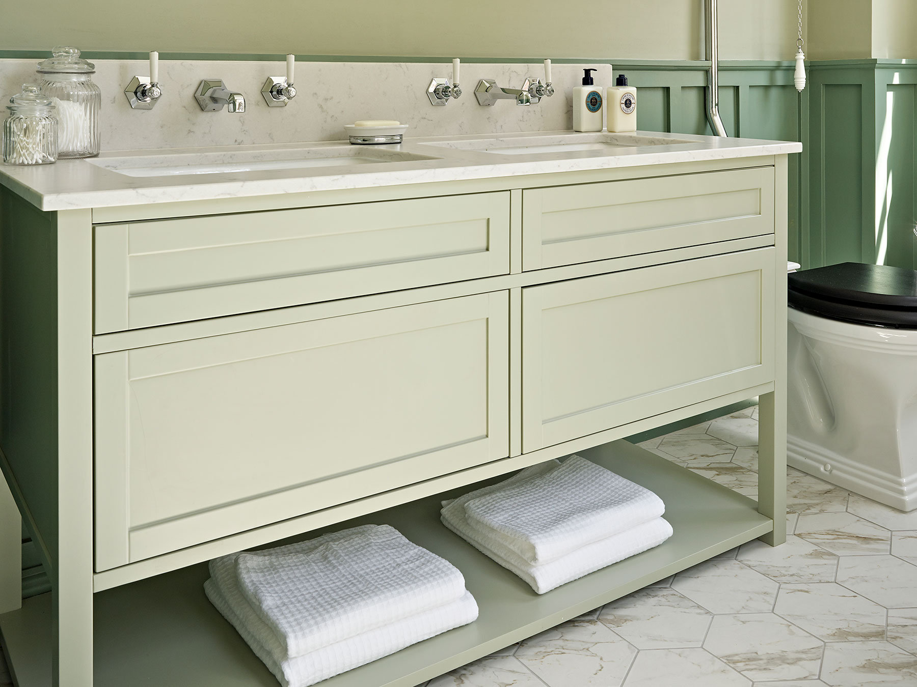 A Shaker style vanity for a traditional style bathroom, featuring a composite worktop and ample storage
